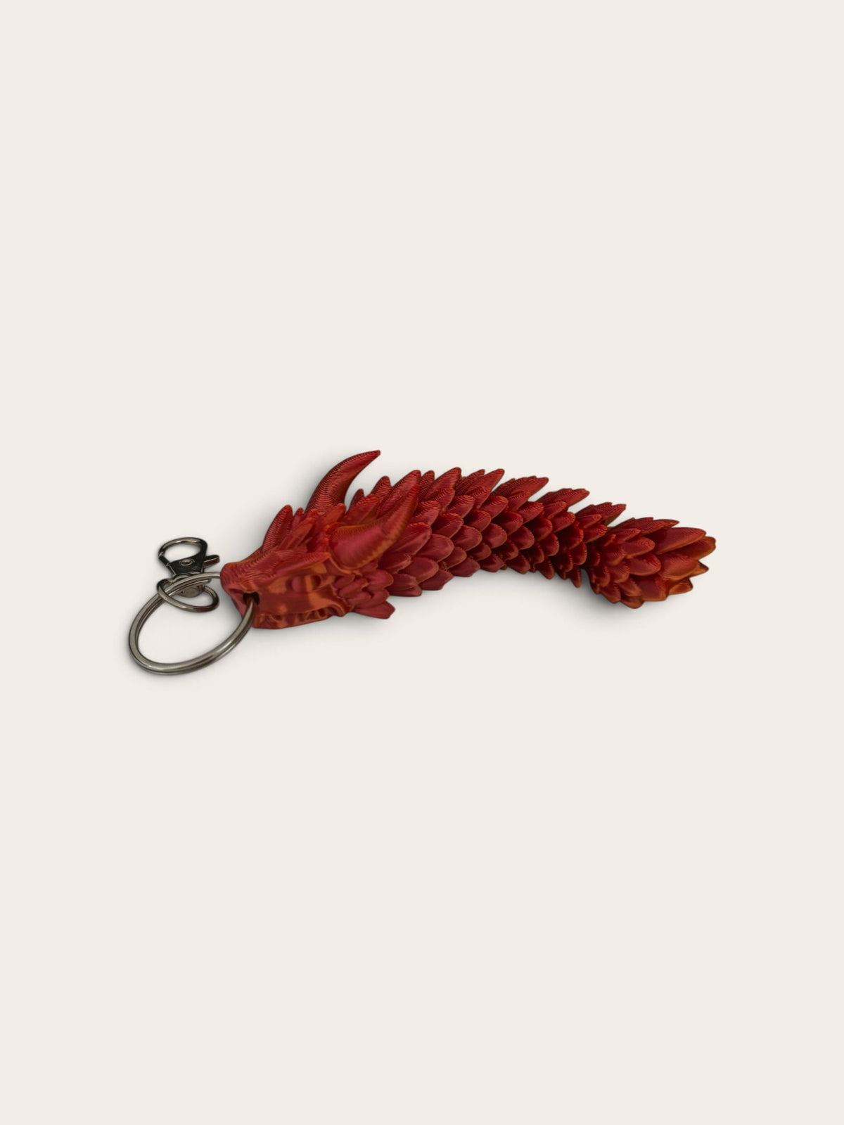 PixelClaw 3D articulated red dragon keychain with detailed 3D-printed scales and flexible body design.
