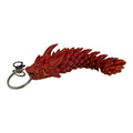 PixelClaw 3D articulated dragon keychain in vibrant red with detailed 3D-printed scales and a metal ring attachment.